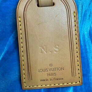 Authentic “Louis Vuitton” luggage tag with heat-stamped initials: “ N . S ”